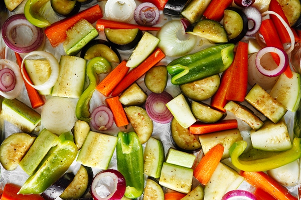 roasted vegetables mix on baking tray food above vegan food background - Камбала с овощами