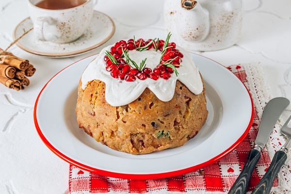 traditional christmas fruit pudding on white festive background - Марципановый кулич симнель