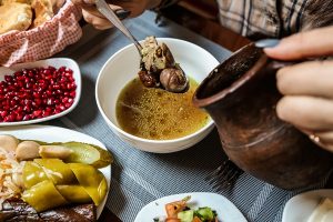 traditional piti soup with lamb meat and vegetables and side snacks top view - Пити