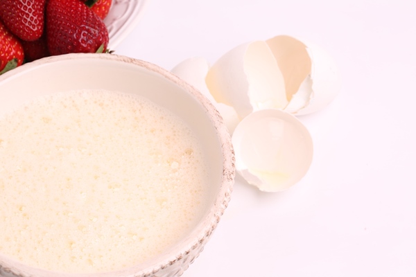 whipped to a froth the eggs in a bowl on a white background selective soft focus - Морковно-творожный мазурек