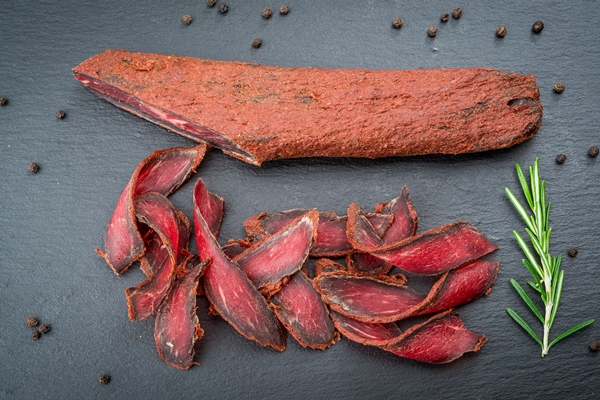 armenian basturma beef cured and spice organic products on a wooden table - Голубцы с черемшой