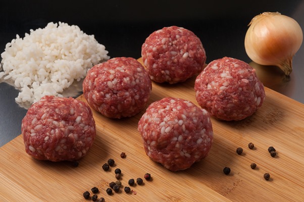 tasty raw beef meatballs with rice on a wooden board - Кюфта-бозбаш