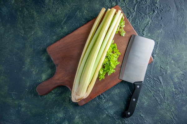 top view fresh green celery with big knife on dark blue background salad health diet food meal color photo - Острый рыбный суп с томатом