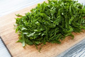 chopped spinach on a wooden cutting board dietary nutrition - Спанакопита