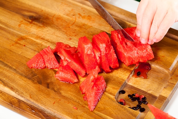 red ripe watermelon cut into pieces sweet ripe red flesh of a ripe watermelon - Мексиканский острый фруктовый салат