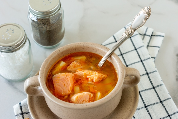homemade soup with salmon with bread sticks on marble background - Суп из лосося с яблоками