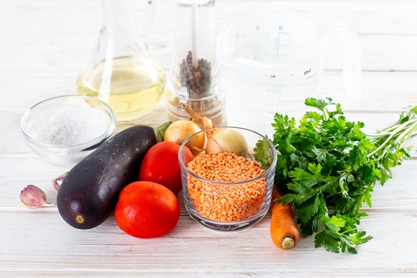 ingredients for making soup with eggplant and lentils on a table healthy veggie recipe - Овощной суп с баклажанами и чечевицей