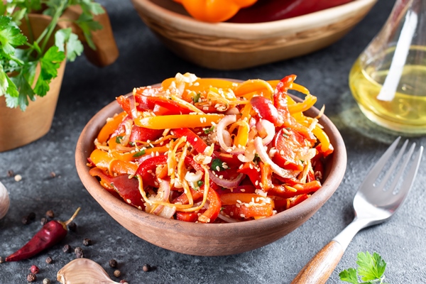 sweet peppers with korean carrots sesame seeds and vegetables in a bowl on a dark background spicy healthy food 1 - Острый салат из болгарского перца с морковью и кунжутом