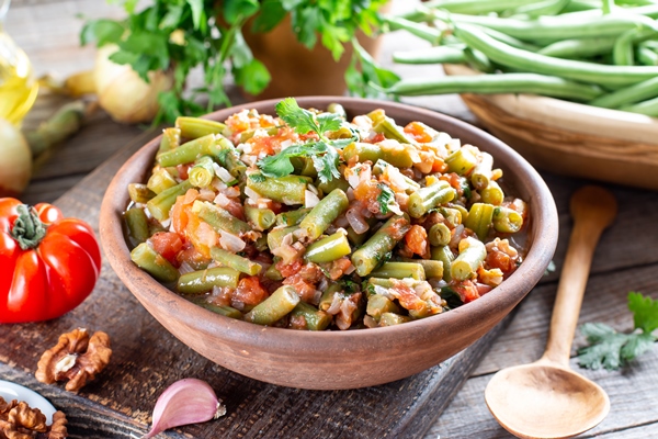 traditional caucasian georgian lobio of green beans with vegetables and tomato selective focus - Лобио из зелёной фасоли с овощами и помидорами