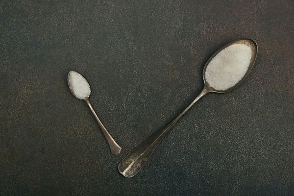 close up flat lay two vintage metal spoons of white sugar and sea salt on dark grunge stone table surface with copy space elevated top view directly above - Закуска овощная "Огонёк"