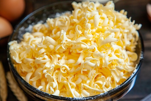 grated butter for baking on table baking ingredients for shortbread pastry grated butter flour eggs sour cream close up on wooden background - Сливочный крем-суп из каштанов (старинный рецепт)