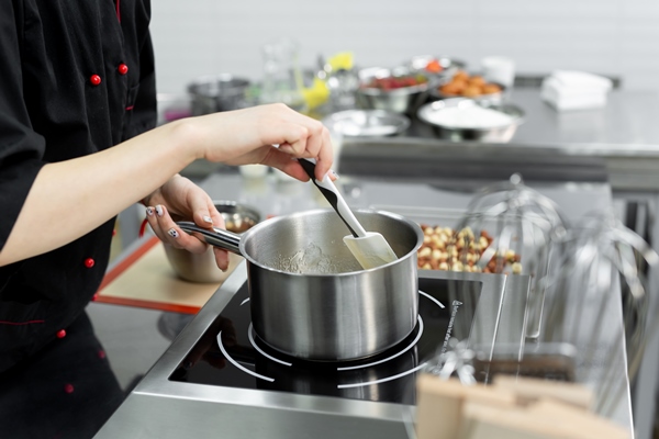 steel pan with boiling and bubbling sugar mass for making caramel - Каштановый крем