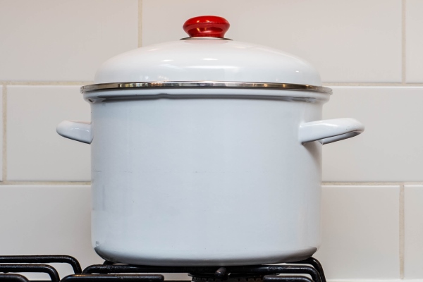 a large stock pot on a stove with vegetables cut for making soup - Цеппелины с грибной начинкой, постный стол
