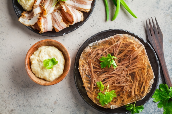 russian pork and beef jellied meat with horseradish and parsley top view traditional russian cuisine concept - Русский столовый хрен