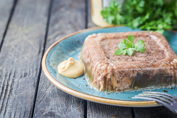 russian traditional homemade jelly meat holodets with mustard and horseradish on the table - Русский столовый хрен