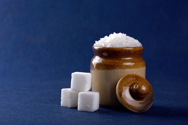sugar white granulated sugar and refined sugar on a blue - Ягодная холодная приправа
