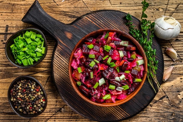 traditional russian salad vinaigrette with boiled vegetables pickled cucumbers in bowl wooden table top view - Русский столовый хрен