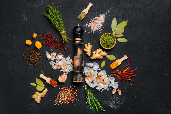 assortment of spice and seasonings scattered on dark background - Куриный рассольник