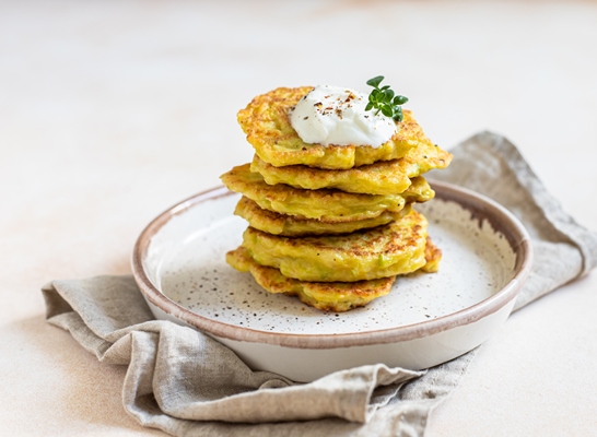 stack of vegetable fritters or pancakes with yoghurt or cream sour dressing and herbs - Глостерский соус (английская кухня)