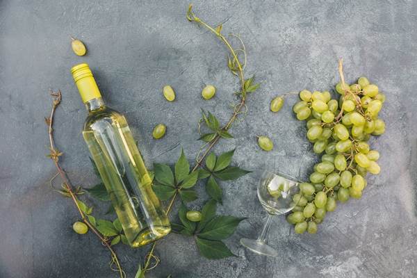 top view of bottle white wine green vine wineglass and ripe grape on vintage gray stone table backgr - Беарнский соус (беарнез)