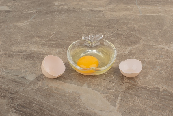 broken egg on plate on marble table - Печёночные котлетки на пару (для детей до 1 года)