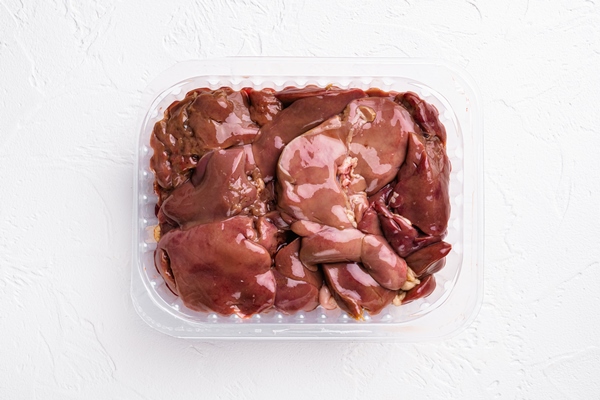 fresh farm turkey liver in plastic pack set on white stone table background top view flat lay with copy space for - Печёночные котлетки на пару (для детей до 1 года)