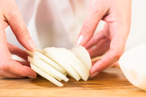 step by step slicing yellow onion with kitchen knife on a cutting board - Печёночные котлеты (для детей 1-2 лет)
