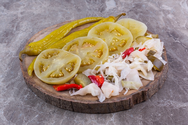 various canned vegetables on a board on the marble - Консервирование пищевых продуктов