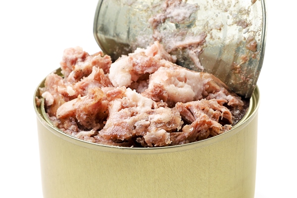 canned meat open close up on a white background isolated - Гречневая каша с тушёнкой