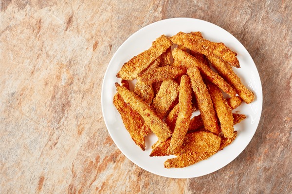 fish sticks fish fillet fingers breaded and deep fried served on a white plate on a ceramic kitchen table horizontal view from above flat lay free space - Корневище кипрея (иван-чая)