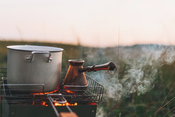 metal pot and turk on the fire morning coffee at the campsite outdoors - Организация трапезы в походе: хранение продуктов, походная кухня, утварь, меню