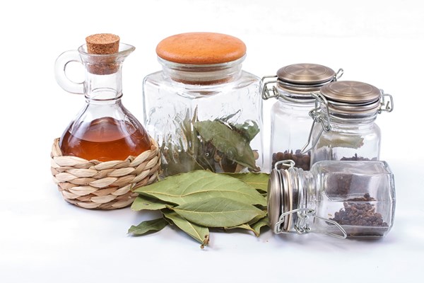 vinegar bottle spices and laurel leaf on the white - Консервированная заправка для рассольника