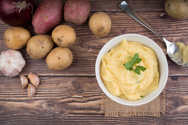 composition with mashed potatoes on wooden table - Калитки карельские