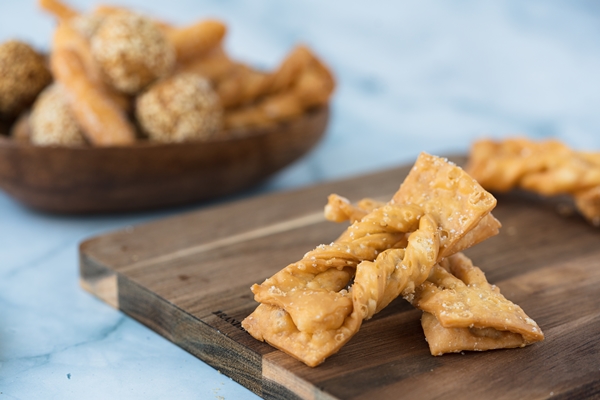 selective focus shot of brushwood cookies on a wooden board - Печенье "Хворост"