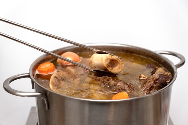 beef bone broth in metal pan bones contain collagen which provides the body with amino acids - Королевский суп-пюре