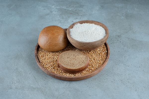 rye bun with bowl of flour on wooden plate - Пеклеванный хлеб