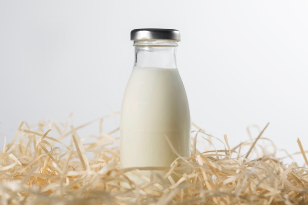 bottle of fresh milk in the hay on a white background healthy food - Блинцы по-королевски