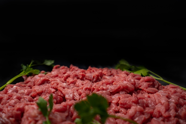 chopped raw meat cut beef into small pieces on blake plate - Сибирские пельмени
