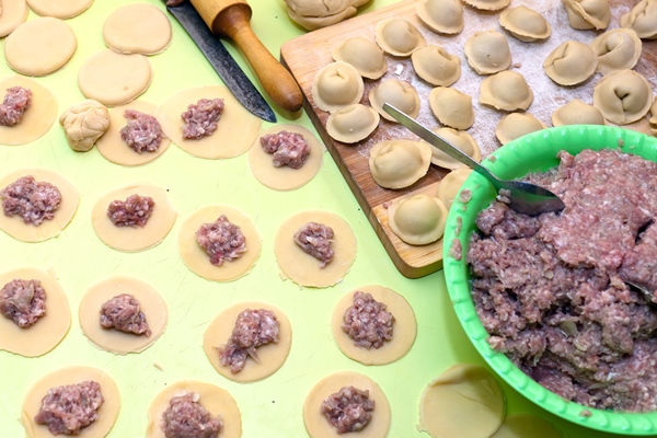 close up of cooking meat dumplings - Пельмени