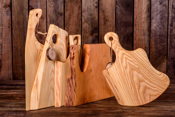 set of beautiful wooden cutting boards on a wooden table cooking in the kitchen - Организация правильного питания детей