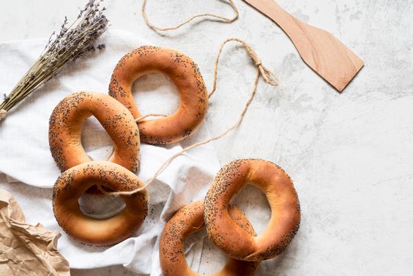 top view poppy seed bagels with string - title=