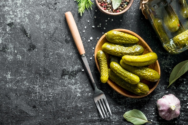 preserved homemade cucumbers plate with fork - Тарталетки с печенью и икрой трески