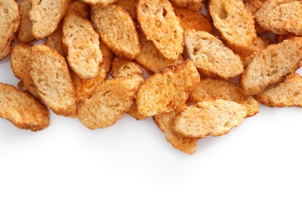 small pieces dried bread isolated white - Овощная икра из шпината