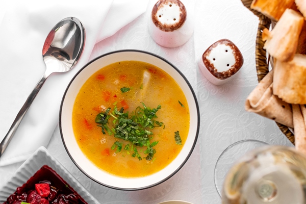 top view chicken soup bowl served with feijoa kompot bread - Блюда из икры на Лазареву субботу