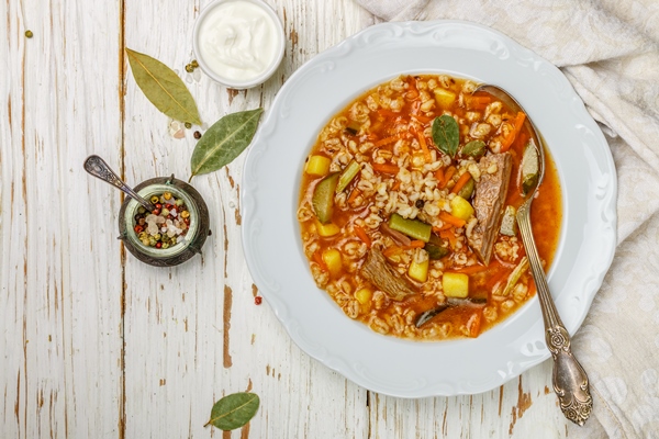 thick hearty pickle soup with beef vegetables pickles carrots onions potatoes tomatoes and pearl barley - Рассольник с патиссонами