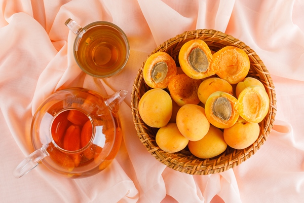 apricots wicker basket with tea flat lay - Компот из абрикосов на зиму