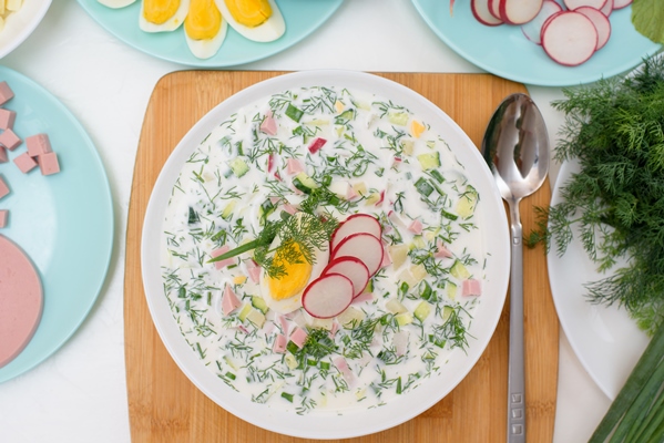 recipe of russian national cold okroshka soup in a white plate on a light - Лучшие летние рецепты: что приготовить в жару