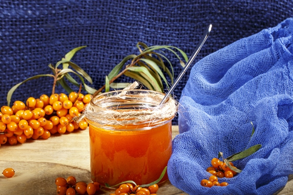 homemade jam glass jar with sea buckthorn jam blue canvas - Варенье из облепихи на сахарном сиропе