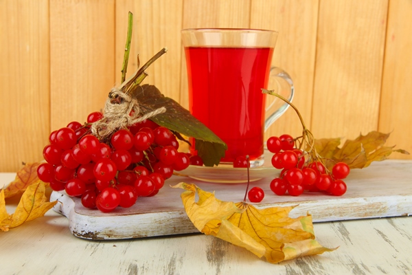 red berries viburnum cup tea table wooden table - Сок из калины