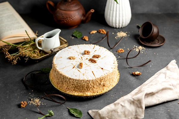 white glazed cake decorated with cake crumbles walnuts 1 - Кабачковый торт со сливочным кремом